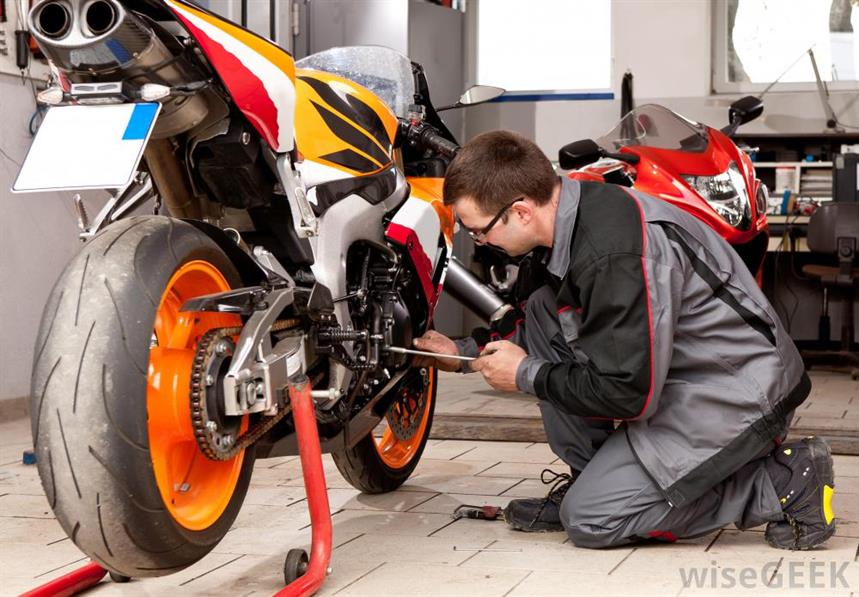 mechanic-fixing-motorcycle-engine.jpg